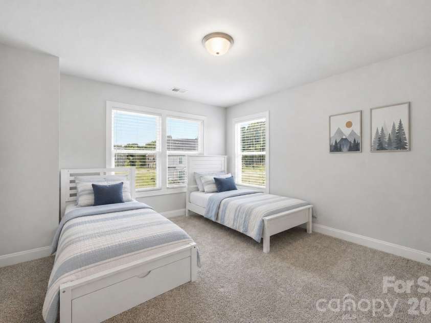 311 Coronado Avenue, Matthews, NC 28104.  MLS# CAR4400272, YatesRealty ID 40201. 3rd Secondary upstairs bedroom **beds frames are actual, bedding is virtual**