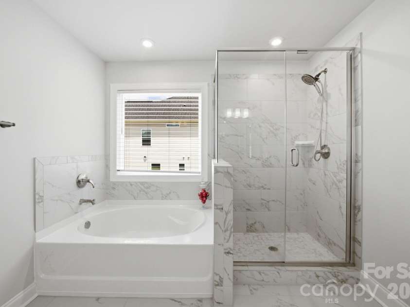 311 Coronado Avenue, Matthews, NC 28104.  MLS# CAR4400272, YatesRealty ID 40201. Primary en-suite with tub and shower.