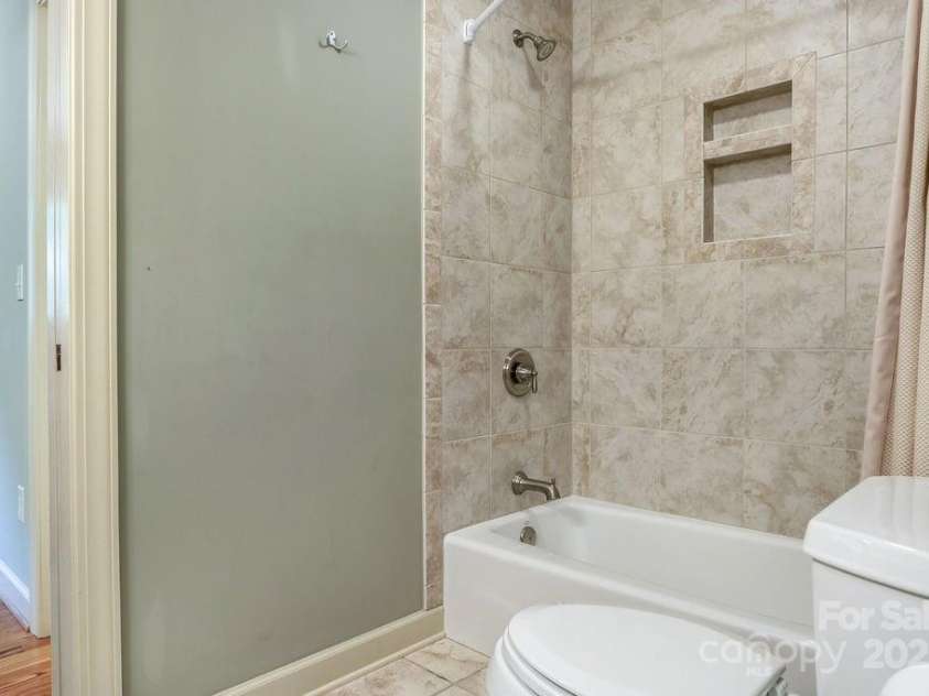 301 Gateway Drive, Hendersonville, NC 28739.  MLS# CAR4294263, YatesRealty ID 40247. Beautiful tile adorns the tub and shower in the second full bathroom upstairs. 