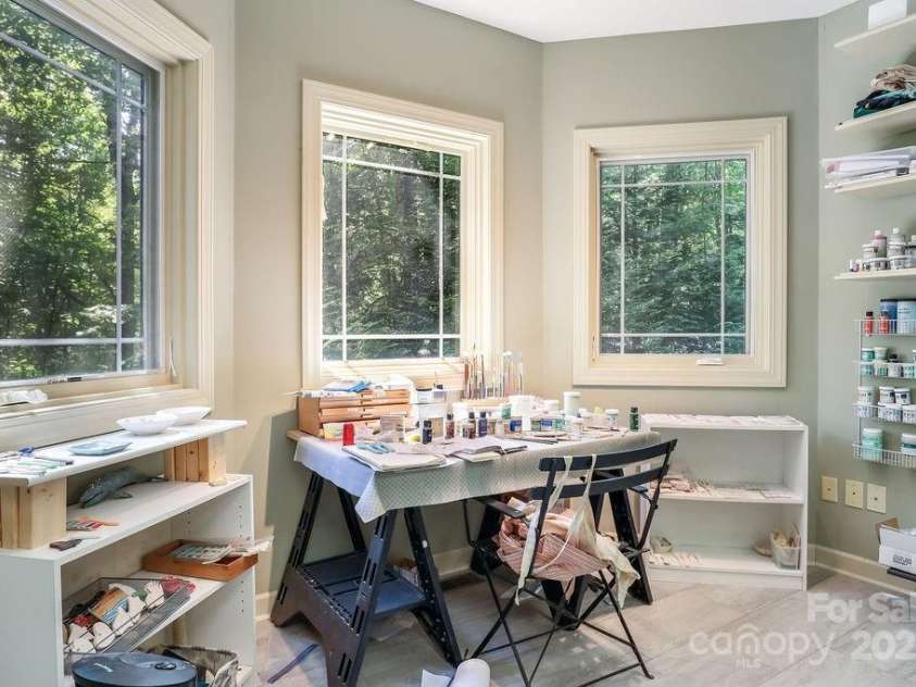 301 Gateway Drive, Hendersonville, NC 28739.  MLS# CAR4294263, YatesRealty ID 40247. Downstairs is another huge flex space. This room was built as an office, but is currently used as a ceramic studio. Adjacent to this room is finished flex space that has double doors leading to the lower level drive