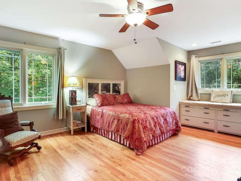 301 Gateway Drive, Hendersonville, NC 28739.  MLS# CAR4294263, YatesRealty ID 40247. Welcome to the ensuite guest bedroom featuring a sun-lit spot for reading. 
