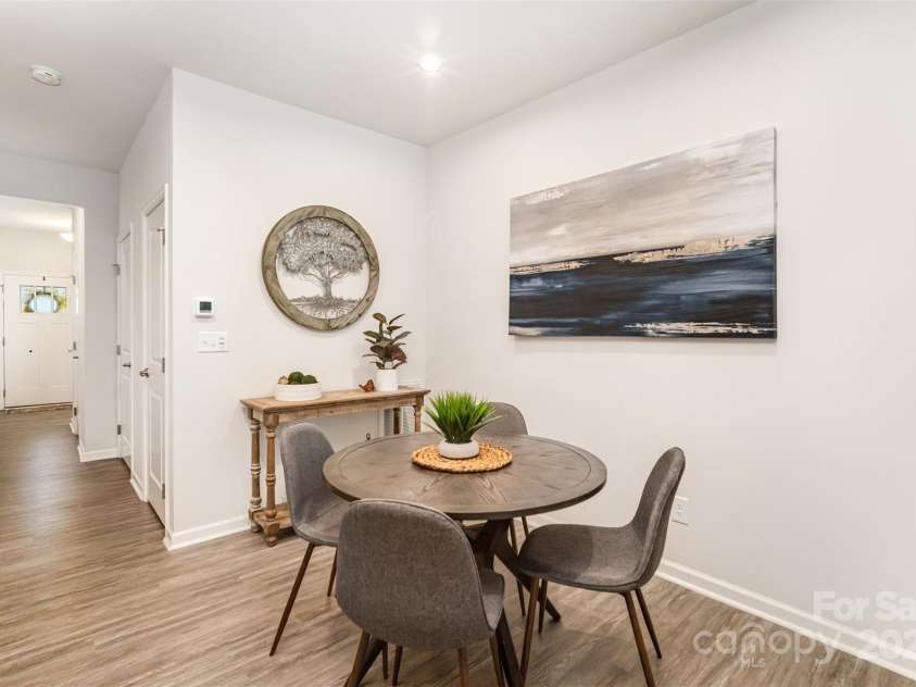 407 Park Meadows Drive, Matthews, NC 28104.  MLS# CAR4287821, YatesRealty ID 40250. Just beyond the dining area, is our walk in pantry, the utility room, and half bath.