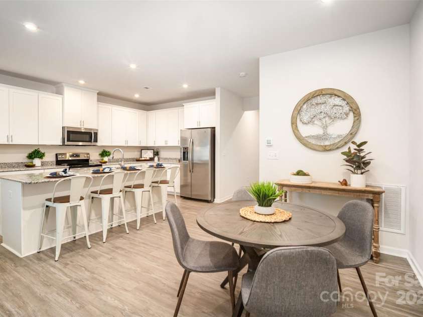 407 Park Meadows Drive, Matthews, NC 28104.  MLS# CAR4287821, YatesRealty ID 40250. Our bright white kitchen with oversized island can accommodate four counter stools as well.