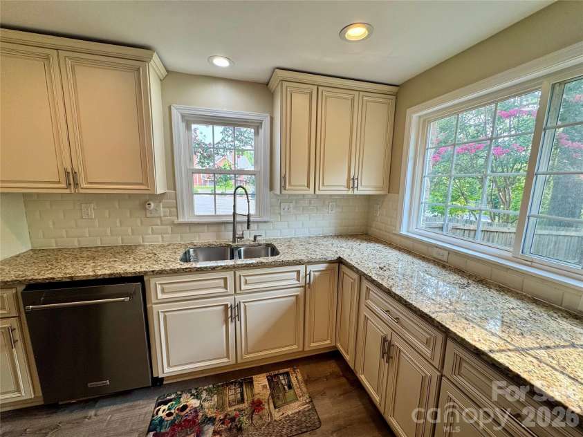 205 Tournament Drive, Concord, NC 28025.  MLS# CAR4407976, YatesRealty ID 40257. Kitchen-subway tile, custom cabinets and granite countertops.