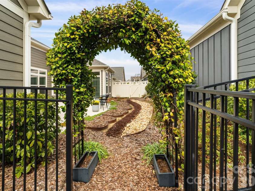 2106 Epworth Court, Waxhaw, NC 28173.  MLS# CAR4356029, YatesRealty ID 4026. Gorgeous trellis/gate with climbing jasmine