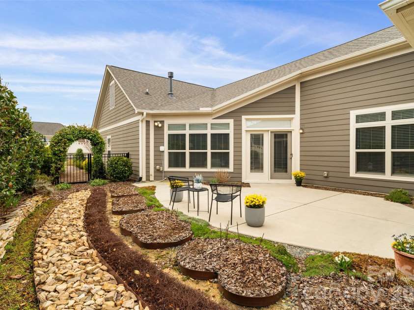 2106 Epworth Court, Waxhaw, NC 28173.  MLS# CAR4356029, YatesRealty ID 4026. Private patio/garden. Trellis with climbing jasmine