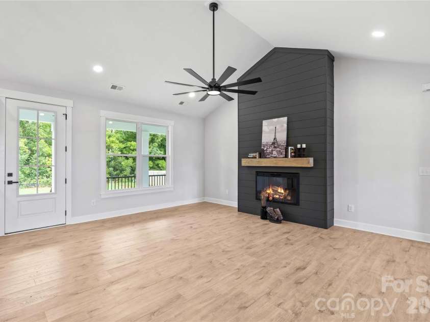 1205 Coppergate Drive, Salisbury, NC 28147.  MLS# CAR4406348, YatesRealty ID 40304. Ship lap wall & electric fireplace included. (This is Den not virtually staged.)