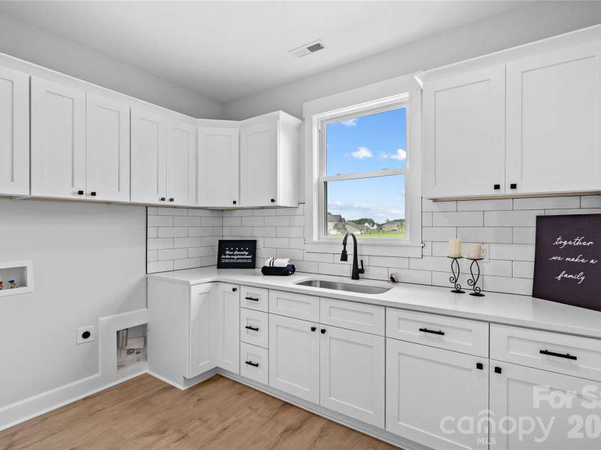 1205 Coppergate Drive, Salisbury, NC 28147.  MLS# CAR4406348, YatesRealty ID 40304. Shows how large Laundry is with utility sink & quartz counters.