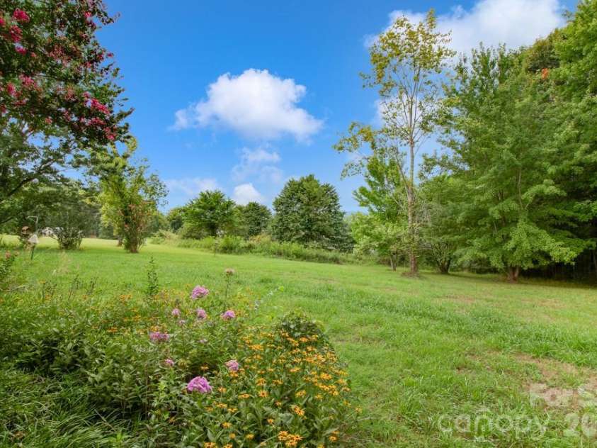 1474 Pea Ridge Road, Mill Spring, NC 28756.  MLS# CAR4407178, YatesRealty ID 40359. Back yard