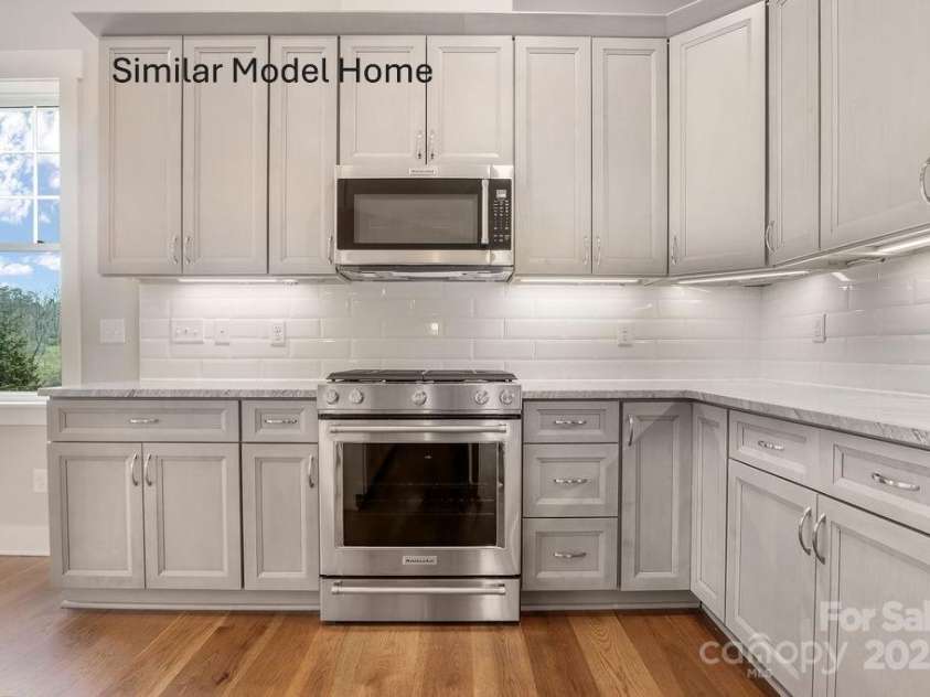93 Creekside View Drive, Asheville, NC 28804.  MLS# CAR4328429, YatesRealty ID 4044. Gas range and vented microwave create a clean, functional cooking setup