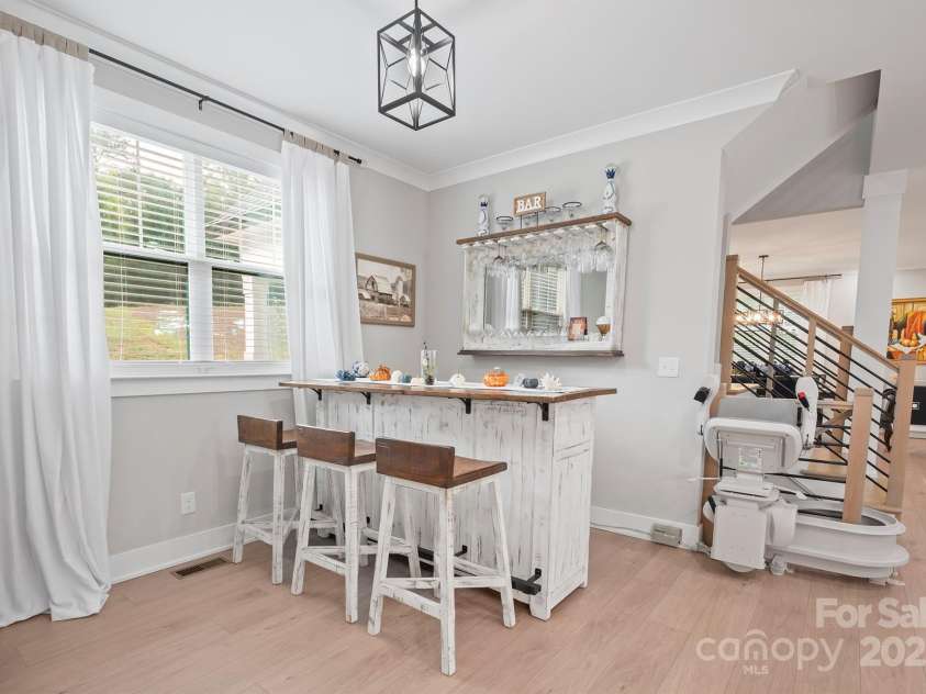685 Knollcrest Drive, Concord, NC 28025.  MLS# CAR4256189, YatesRealty ID 4045. Breakfast area currently used as a bar area.  Chairlift leading to basement