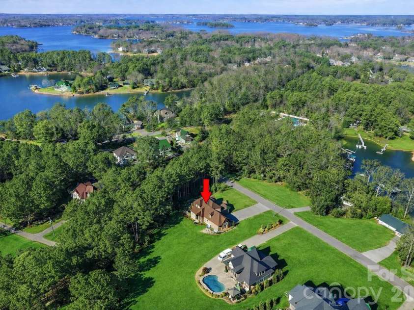 108 Washam Road, Mooresville, NC 28117.  MLS# CAR4334255, YatesRealty ID 4048. Breathtaking aerial perspective highlighting this home’s proximity to Lake Norman, nestled among mature trees and upscale waterfront estates. A rare blend of privacy, natural beauty, and lake living.