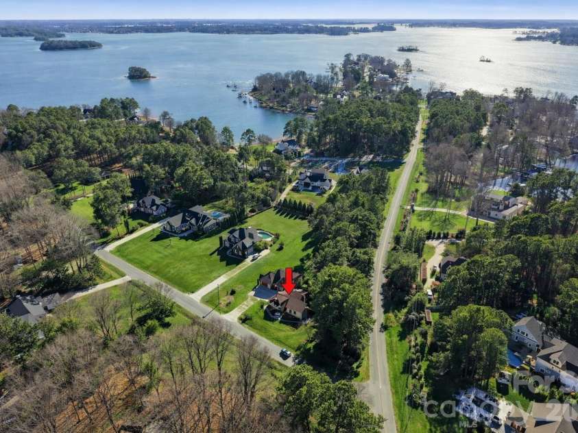 108 Washam Road, Mooresville, NC 28117.  MLS# CAR4334255, YatesRealty ID 4048. Breathtaking aerial perspective highlighting this home’s proximity to Lake Norman, nestled among mature trees and upscale waterfront estates. A rare blend of privacy, natural beauty, and lake living.