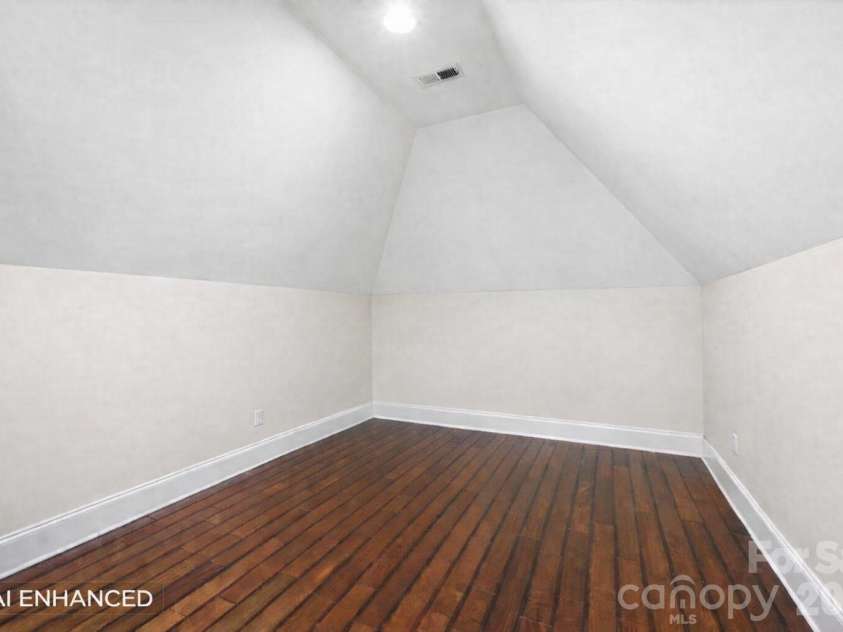 108 Washam Road, Mooresville, NC 28117.  MLS# CAR4334255, YatesRealty ID 4048. Bright bonus or flex room with vaulted ceilings, hardwood floors, and neutral walls that create an open, airy feel. The space offers a simple layout ideal for a playroom, home office, or additional living area.