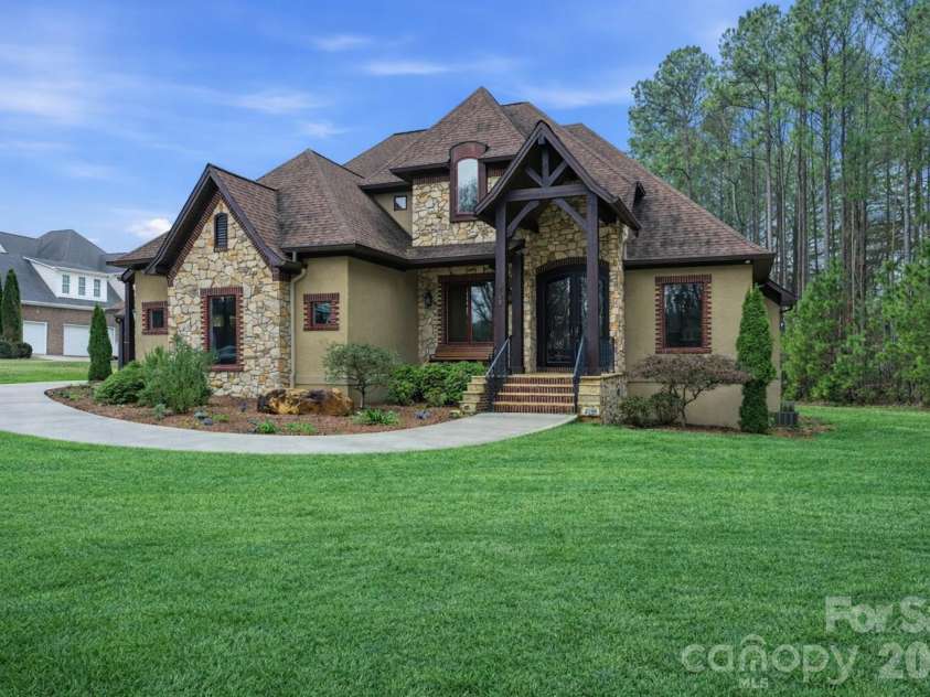 108 Washam Road, Mooresville, NC 28117.  MLS# CAR4334255, YatesRealty ID 4048. Custom home featuring stone accents, brick trim, and a dramatic covered entryway.