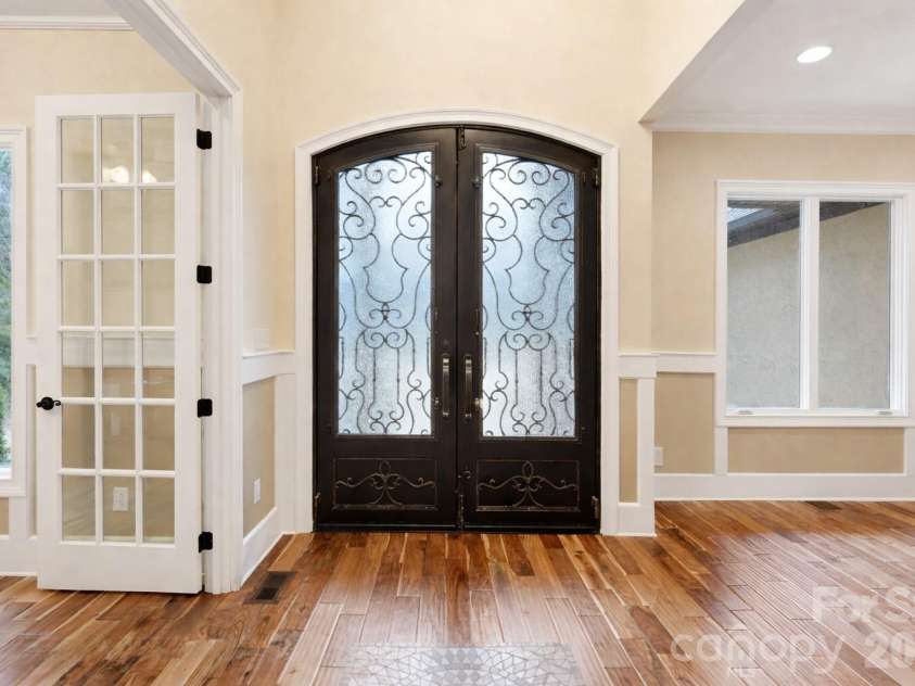 108 Washam Road, Mooresville, NC 28117.  MLS# CAR4334255, YatesRealty ID 4048. Elegant entry area featuring decorative double Wrought-iron front doors with frosted glass details.