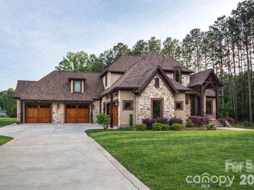 108 Washam Road, Mooresville, NC 28117.  MLS# CAR4334255, YatesRealty ID 4048. Rare four car garage with workshop space perfect for car enthusiasts and extra storage.