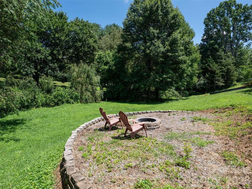 10 Ashe Road, Candler, NC 28715.  MLS# CAR4408371, YatesRealty ID 40538. Firepit in back yard