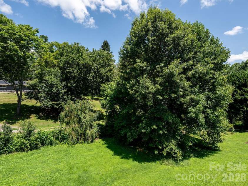 10 Ashe Road, Candler, NC 28715.  MLS# CAR4408371, YatesRealty ID 40538. Lovely back yard