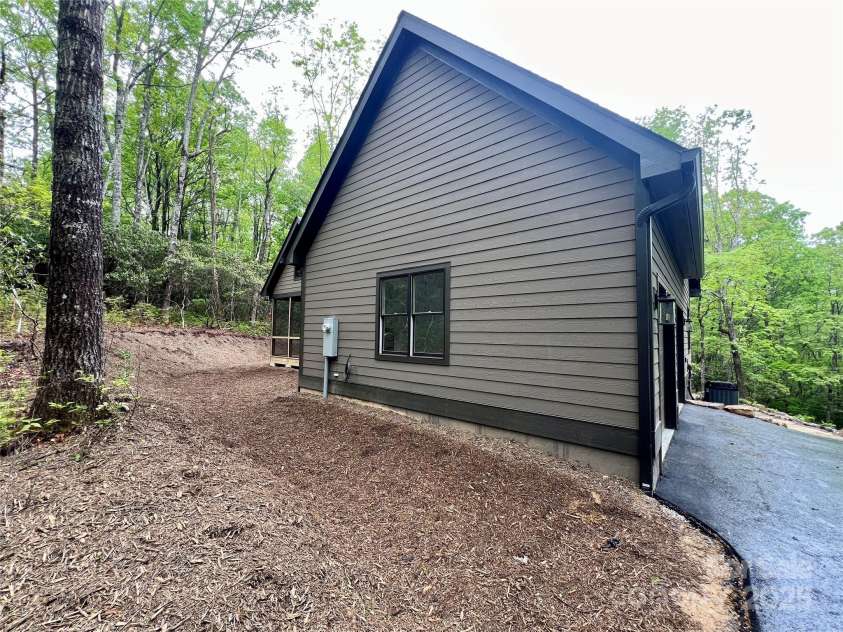 435 Soquili Drive, Brevard, NC 28712.  MLS# CAR4255595, YatesRealty ID 4064. Side of House