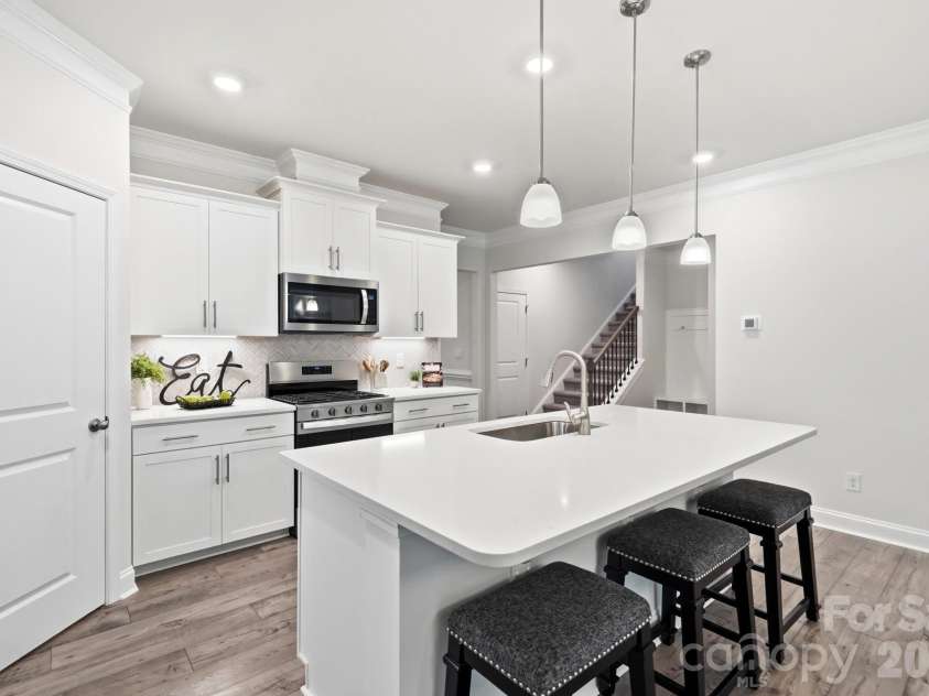 115 Shayna Road, Troutman, NC 28166.  MLS# CAR4407624, YatesRealty ID 40740. Clean lines, abundant storage, and thoughtful design make this kitchen shine.