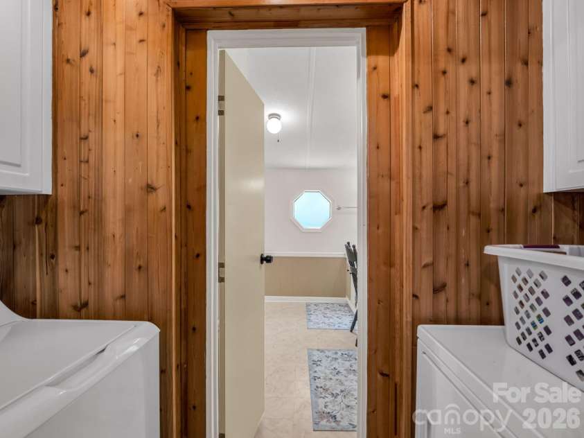 1120 Sandy Plains Road, Tryon, NC 28782.  MLS# CAR4407780, YatesRealty ID 40748. Laundry Room Off Kitchen and Primary Bath