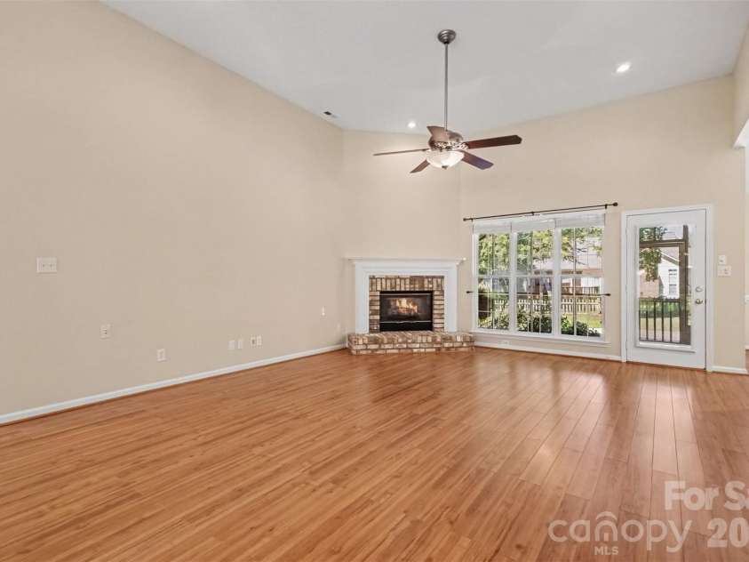576 Gatsby Place, Concord, NC 28027.  MLS# CAR4403002, YatesRealty ID 40800. Beautiful flooring flows seamlessly throughout the Great Room, Kitchen, Breakfast Room, and Dining Room. A wall of windows across the back fills the space with natural light, and the living area is anchored by a cozy gas fi
