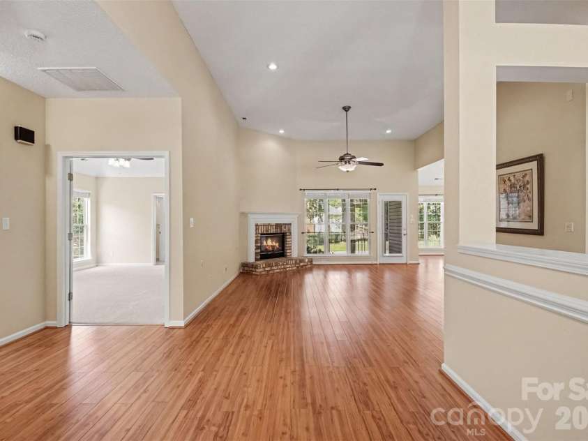 576 Gatsby Place, Concord, NC 28027.  MLS# CAR4403002, YatesRealty ID 40800. View from the front door looking into the expansive great room. The open-concept design flows seamlessly from the great room to the inviting screened porch, perfect for indoor-outdoor living. This functional split floor pla