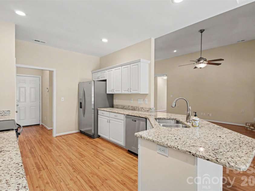 576 Gatsby Place, Concord, NC 28027.  MLS# CAR4403002, YatesRealty ID 40800. View from the kitchen looking into the spacious great room, featuring a convenient and inviting bar area perfect for entertaining guests.