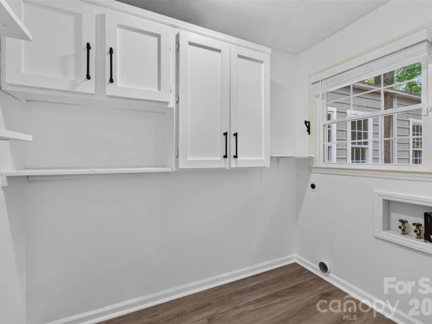 2602 Shearer Drive, Statesville, NC 28625.  MLS# CAR4408375, YatesRealty ID 40815. Laundry room just off the kitchen with additional cabinets.