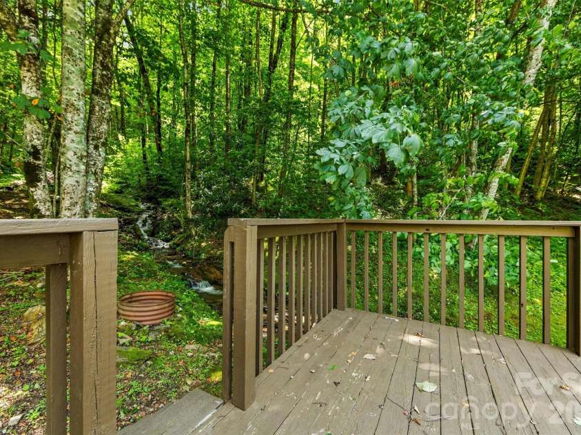 670 Parkway Drive, Maggie Valley, NC 28751.  MLS# CAR4405565, YatesRealty ID 40834. Lower deck by the creek