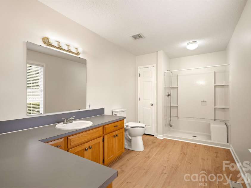 3892 Stoney Creek Drive, Lincolnton, NC 28092.  MLS# CAR4391090, YatesRealty ID 40864. Primary bath featuring a spacious single vanity, walk-in shower, and ample storage.