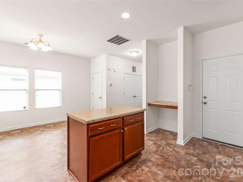 8411 Romana Red Lane, Charlotte, NC 28213.  MLS# CAR4406606, YatesRealty ID 40895. In the kitchen looking into the dining space. Note the closet for storage!