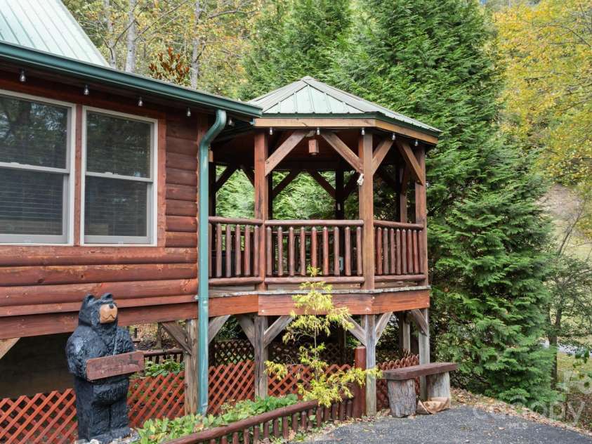 80 Slow Lane, Whittier, NC 28789.  MLS# CAR4307656, YatesRealty ID 4098. House with right side gazebo (off main bedroom)