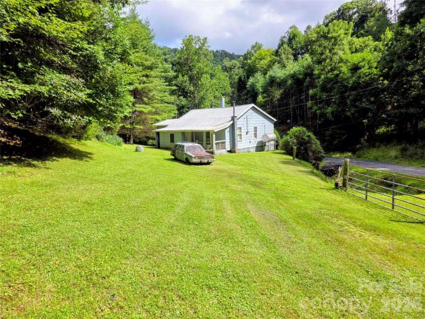 98 Will Wilson Road, Burnsville, NC 28714.  MLS# CAR4406870, YatesRealty ID 40987. House and lawn