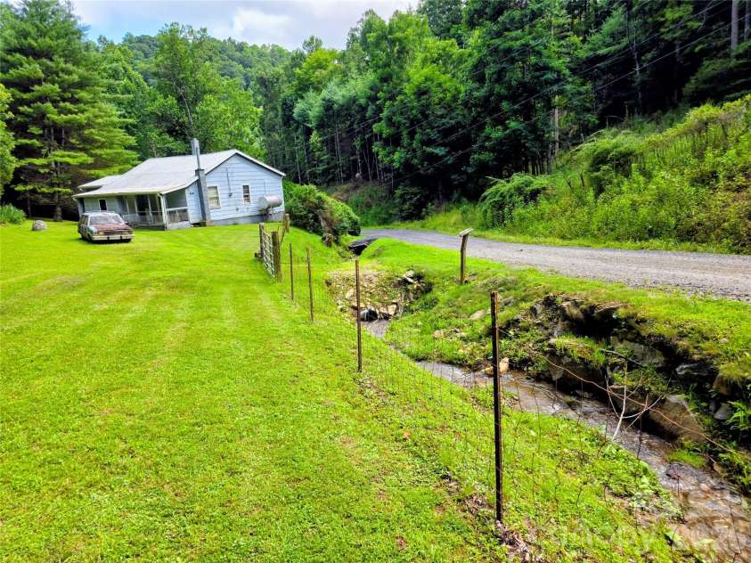 98 Will Wilson Road, Burnsville, NC 28714.  MLS# CAR4406870, YatesRealty ID 40987. House and lawn