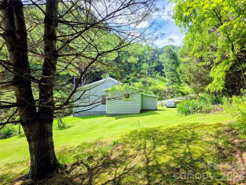98 Will Wilson Road, Burnsville, NC 28714.  MLS# CAR4406870, YatesRealty ID 40987. House and lawn