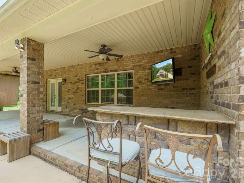 589 Shepherd Road, Troutman, NC 28166.  MLS# CAR4405314, YatesRealty ID 40988. Covered back patio built in bar