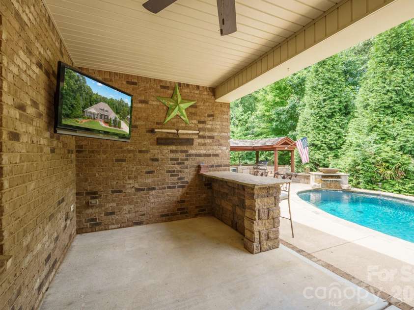 589 Shepherd Road, Troutman, NC 28166.  MLS# CAR4405314, YatesRealty ID 40988. Covered back patio leading to pool deck