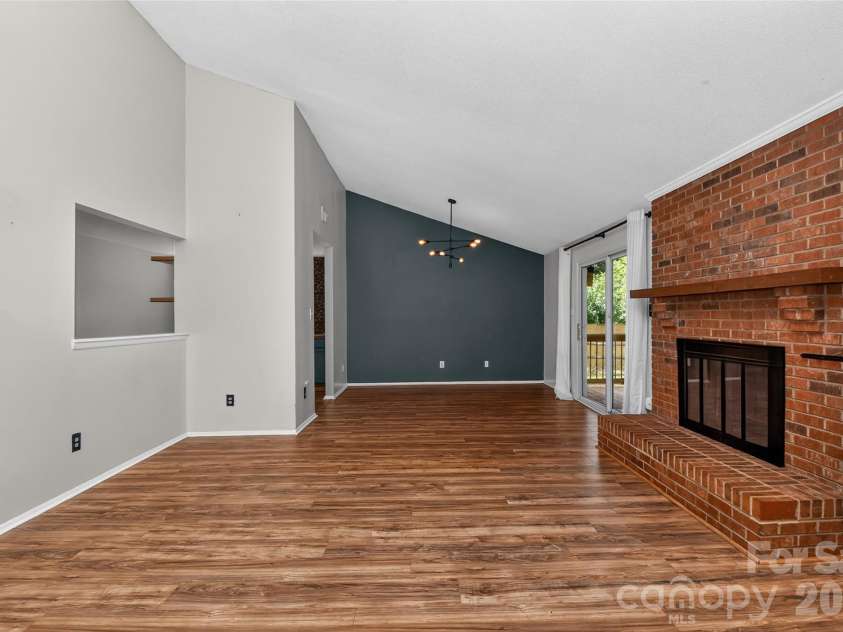 5900 Tillery Drive, Charlotte, NC 28226.  MLS# CAR4406670, YatesRealty ID 41096. Great room with fireplace open to dining room abd showing window into kitchen