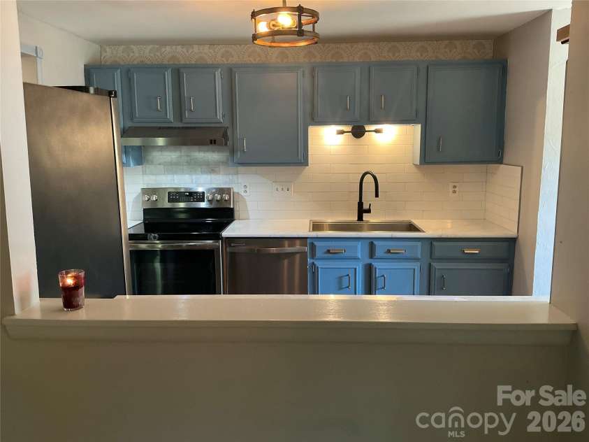 5900 Tillery Drive, Charlotte, NC 28226.  MLS# CAR4406670, YatesRealty ID 41096. Window into kitchen showing off new white subway tile backsplash