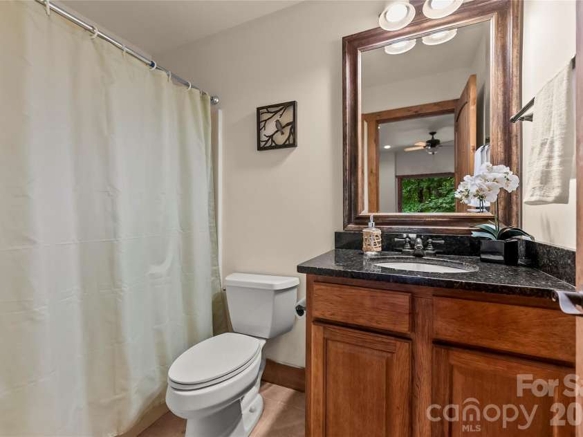 129 Nodatsi Court, Brevard, NC 28712.  MLS# CAR4407587, YatesRealty ID 41149. Lower level bath offers a shower / tub combo