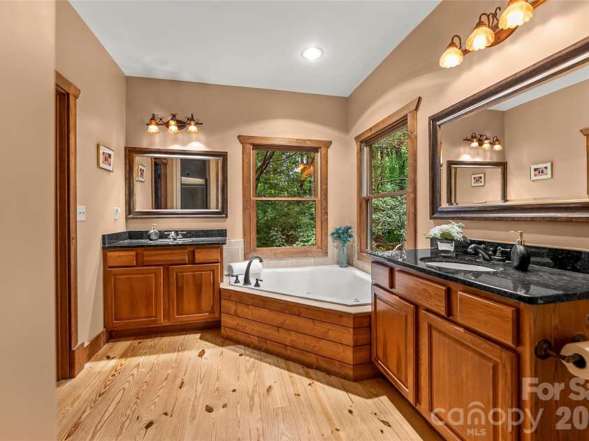129 Nodatsi Court, Brevard, NC 28712.  MLS# CAR4407587, YatesRealty ID 41149. Primary bath delivers his & hers granite vanities