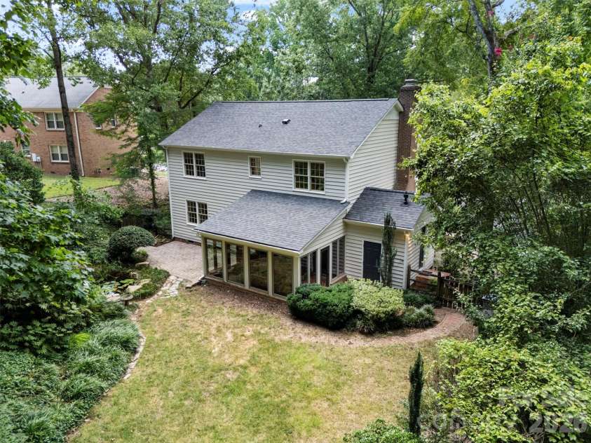 7721 Bradenton Drive, Charlotte, NC 28210.  MLS# CAR4408258, YatesRealty ID 41159. Aerial View – Elevated aerial perspective showcasing the home's rear elevation, generous backyard, and surrounding mature trees.