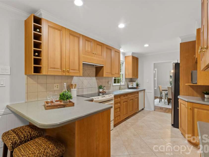 7721 Bradenton Drive, Charlotte, NC 28210.  MLS# CAR4408258, YatesRealty ID 41159. Kitchen – Another view of the kitchen highlighting the generous prep space, plentiful storage, and seamless connection to adjacent living areas.