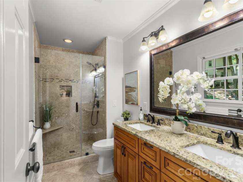 7721 Bradenton Drive, Charlotte, NC 28210.  MLS# CAR4408258, YatesRealty ID 41159. Primary Bathroom – Well-appointed primary bath featuring a dual-sink vanity, large mirror, and a spacious walk-in shower.