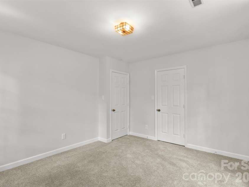 7721 Bradenton Drive, Charlotte, NC 28210.  MLS# CAR4408258, YatesRealty ID 41159. Secondary Bedroom – Versatile bedroom with ample closet space and a light-filled layout suitable for guests, work, or everyday living.