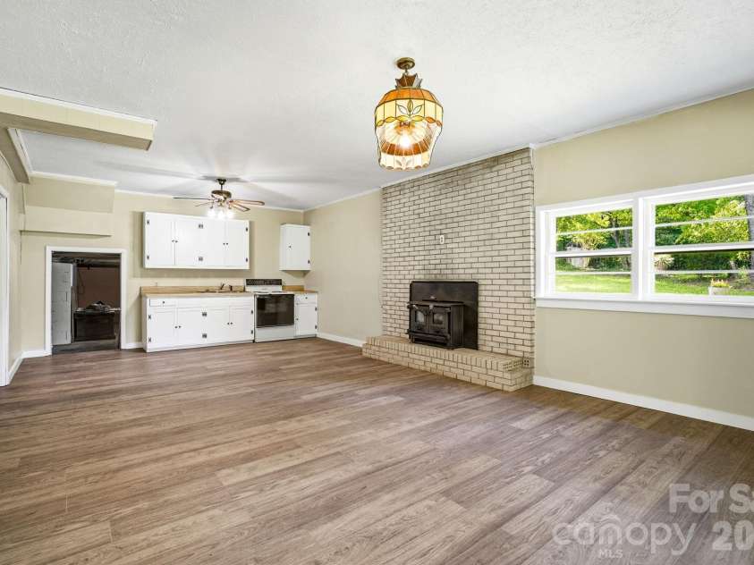 2619 Hopewell Church Road, Sherrills Ford, NC 28673.  MLS# CAR4265772, YatesRealty ID 4123. Functional downstairs kitchen with potential to create a second living quarters, providing flexibility and room for renovation or entertaining. High-efficiency insert delivers cozy heat and style.