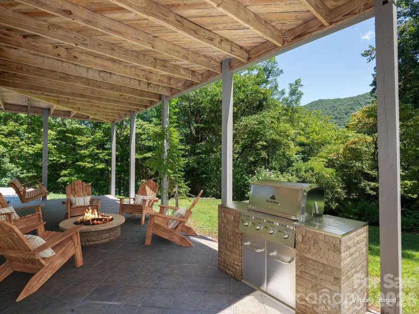 1572 Brushy Fork Road, Sylva, NC 28779.  MLS# CAR4404405, YatesRealty ID 41243. Virtually Staged including grill. Private terrace just off the recreation room suite—creating the perfect indoor-outdoor retreat for relaxation and enjoyment.