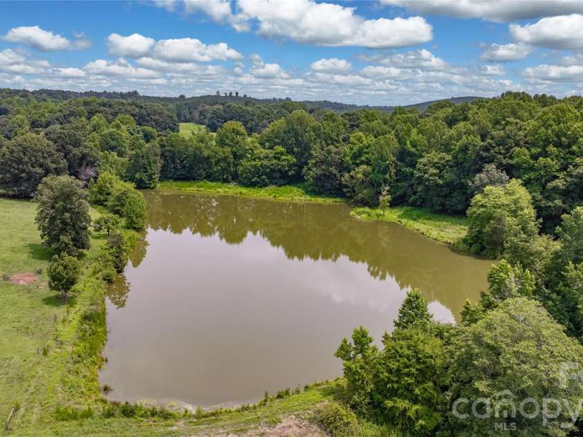 4988 Amick Lane, Liberty, NC 27298.  MLS# CAR4408844, YatesRealty ID 41277. Large pond